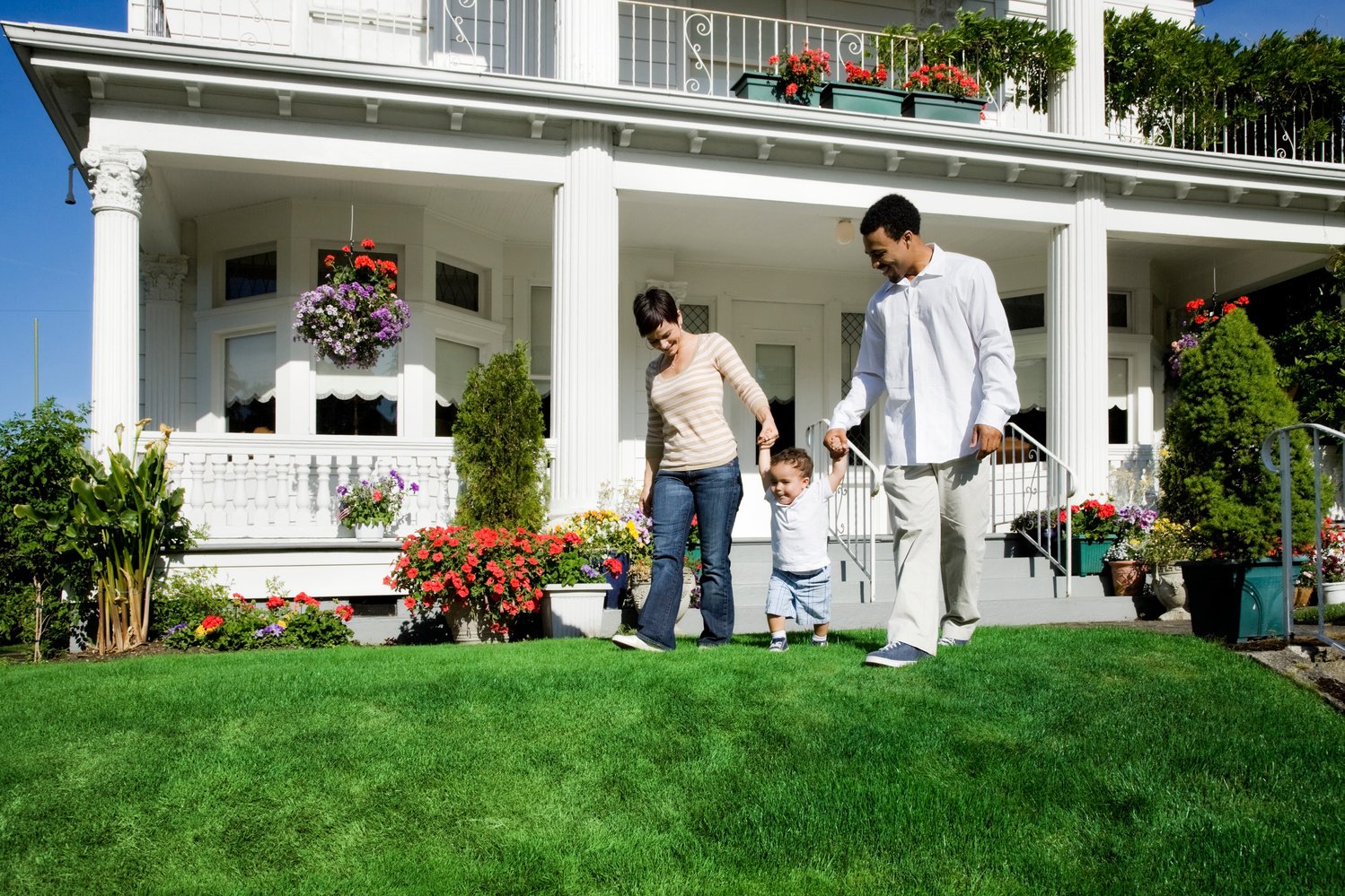 Family of Three Walking in Front Yard